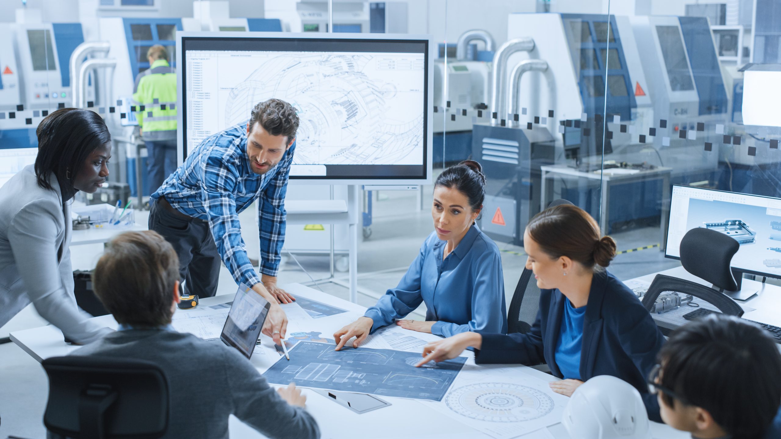 Modern Factory Office Meeting Room: Busy Diverse Team of Engineers, Managers and Investors Talking at Conference Table, Use Interactive TV, Analyze, Find Solutions, Debate and Discuss Engine Concept